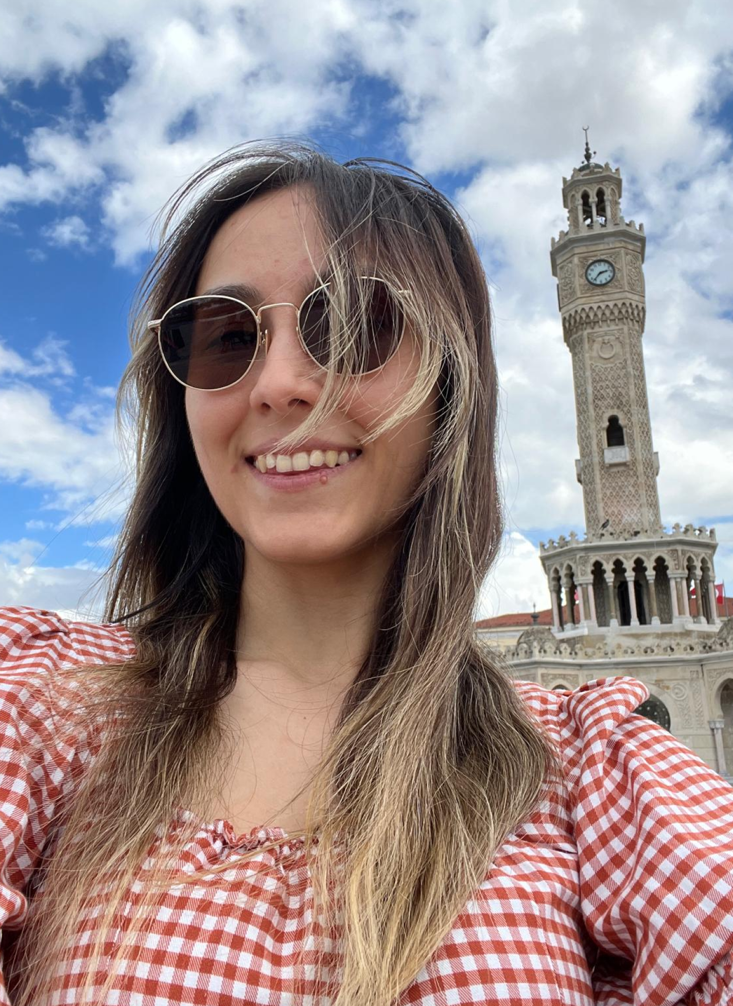 Arzu taking a selfie in front of a historic clock tower